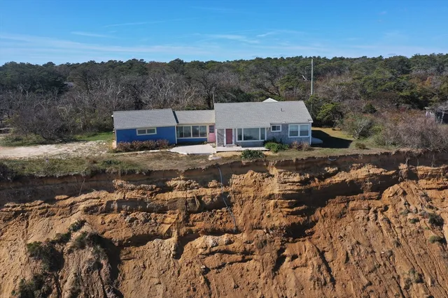 an aerial view of a house with a yard