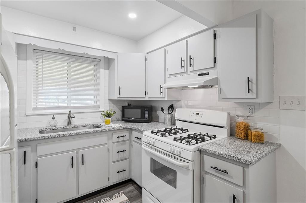 716 School Street McKees Rocks, PA 15136 - Photo 11 of 25 a kitchen with cabinets appliances a sink and a window