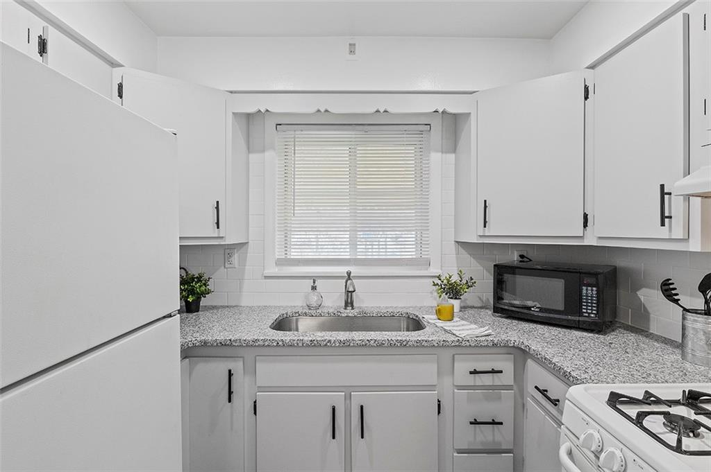 716 School Street McKees Rocks, PA 15136 - Photo 12 of 25 a kitchen with granite countertop a sink stainless steel appliances and cabinets