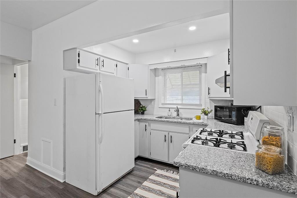 716 School Street McKees Rocks, PA 15136 - Photo 9 of 25 a kitchen with stainless steel appliances granite countertop a refrigerator sink and stove