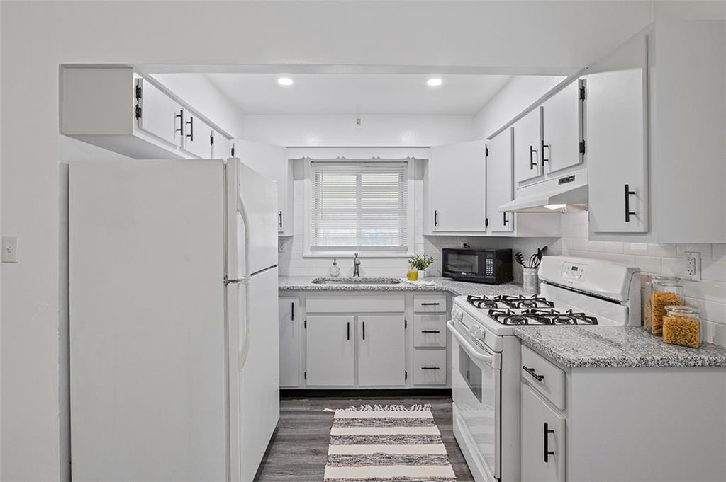 716 School Street McKees Rocks, PA 15136 - Photo 10 of 25 a kitchen with stainless steel appliances a refrigerator sink and cabinets