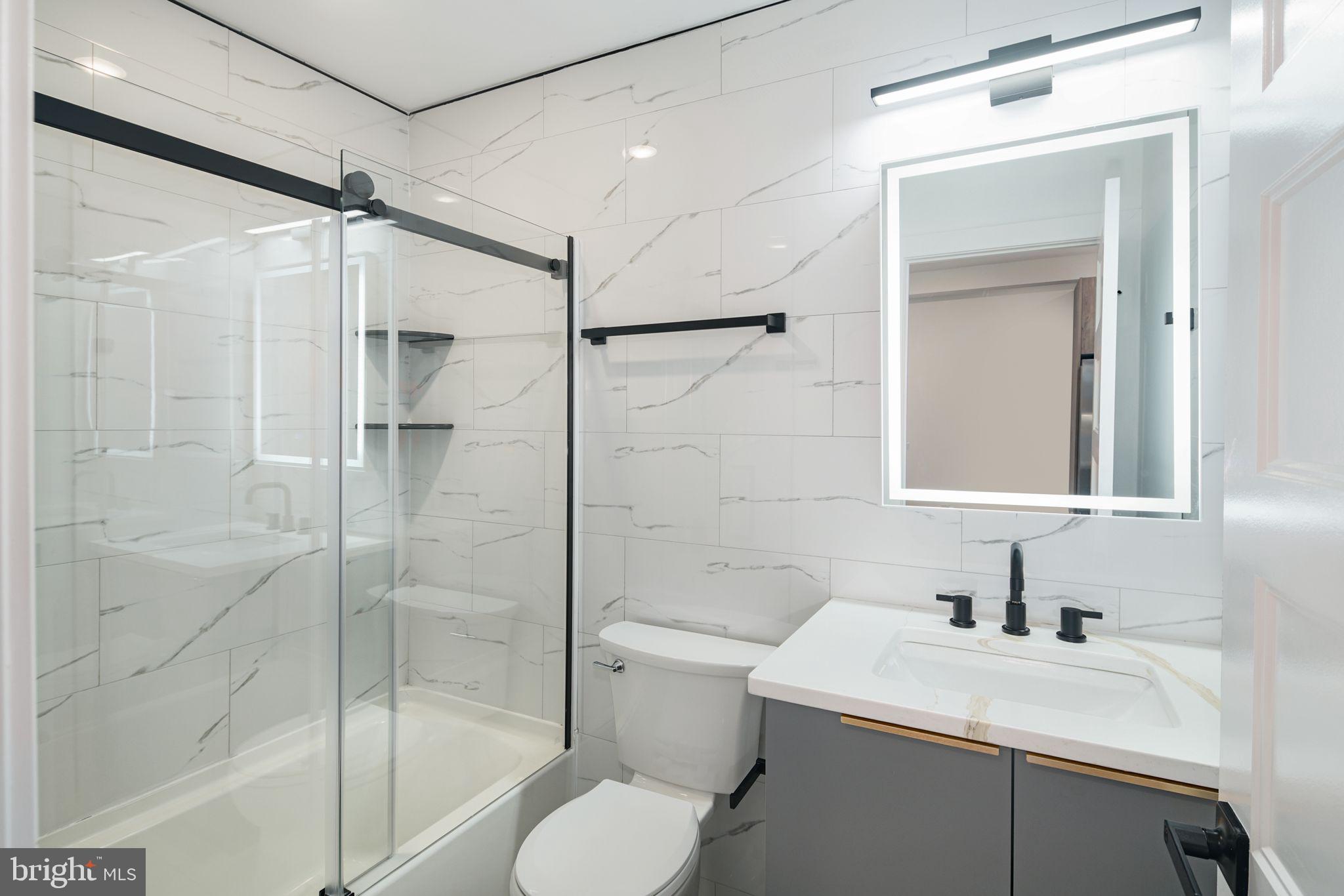 2000 North Front Street, Unit 15 Philadelphia, PA 19122 - Photo 6 of 19 a bathroom with a sink toilet vanity and shower