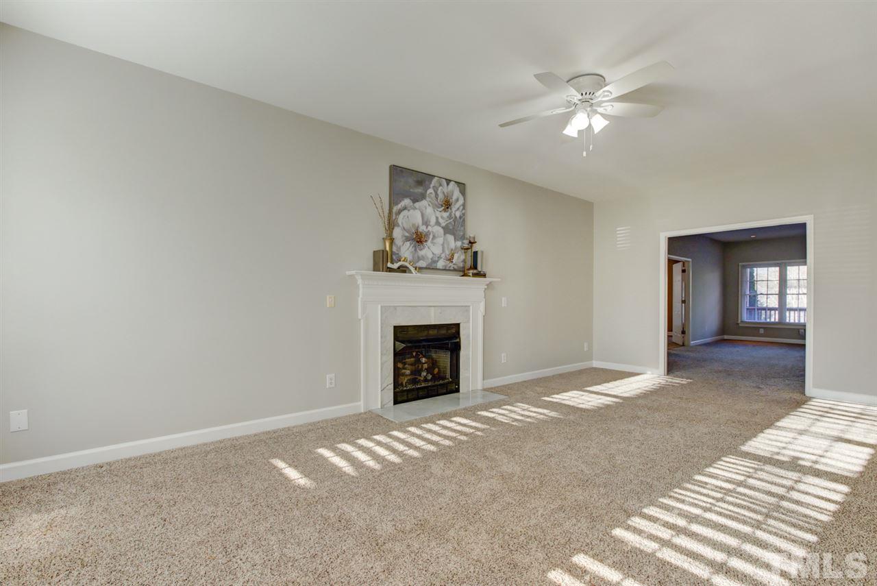 7220 Ridgeline Drive Raleigh, NC 27613 - Photo 12 of 16 Bright living room with cozy fire place and open to family room.