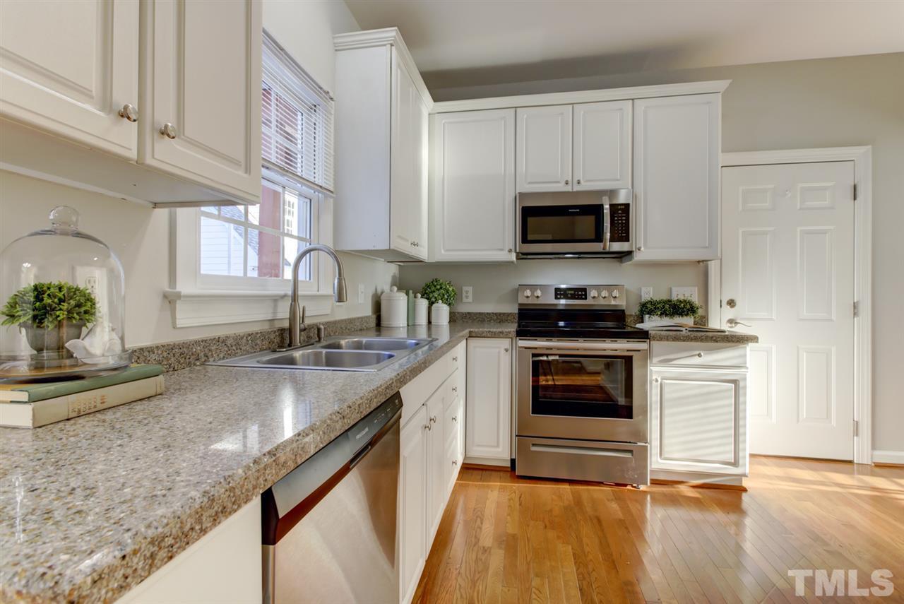7220 Ridgeline Drive Raleigh, NC 27613 - Photo 4 of 16 GRANITE counters and new STAINLESS STEEL appliances are a few of the great features of the Kitchen. The hardwood floors continue through the breakfast area, hallway and into the separate dining room.