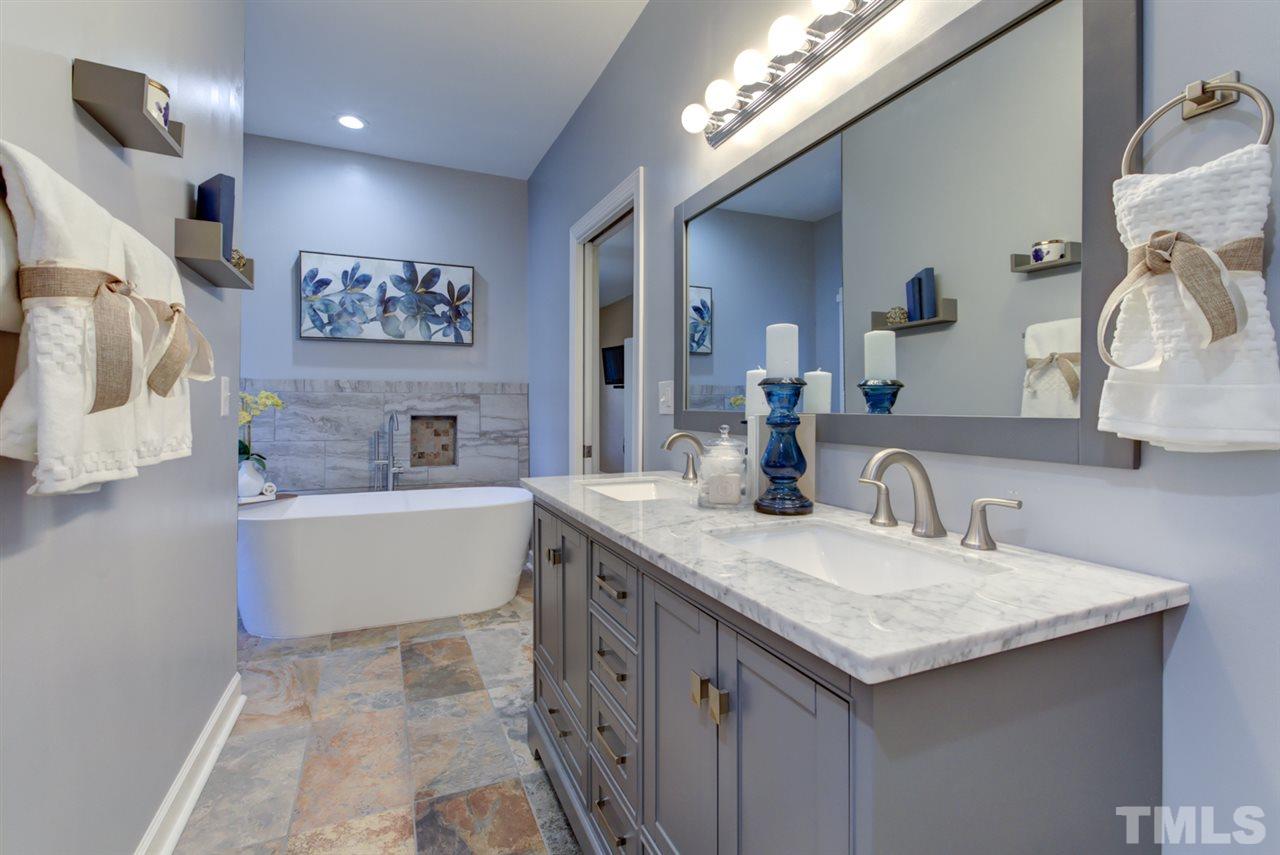 7220 Ridgeline Drive Raleigh, NC 27613 - Photo 6 of 16 The gorgeous master bath has quartz counters and gorgeous tile work and a large soaking tub. Everything you need for relaxing after a long day. or for your in-laws!