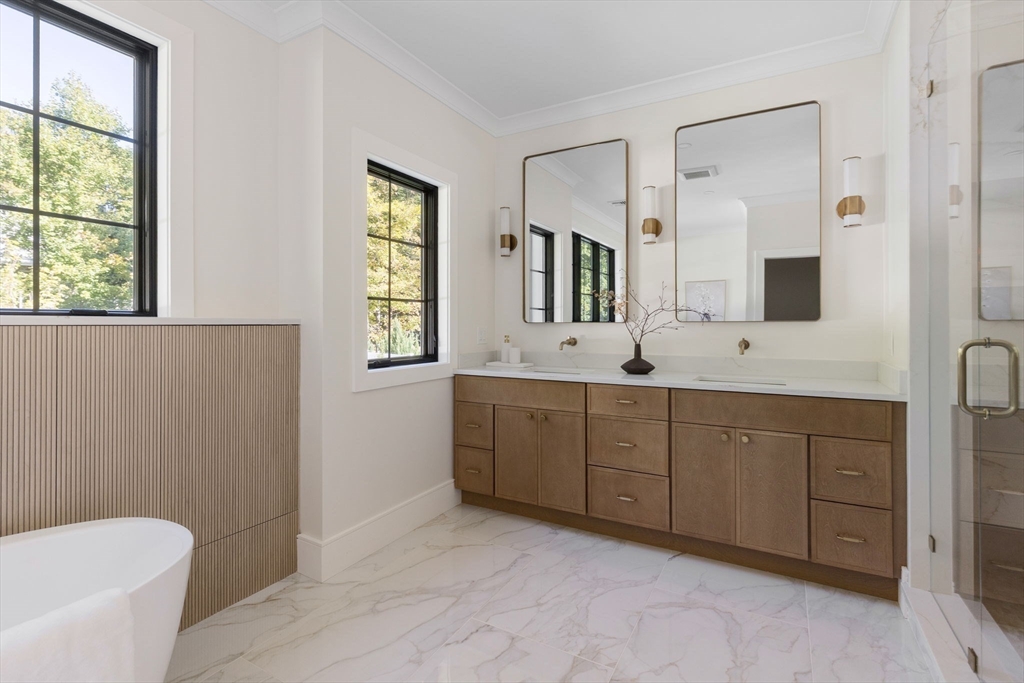 310 Oakland Street Wellesley, MA 02481 - Photo 24 of 33 a spacious bathroom with a double vanity sink a large mirror and a bathtub