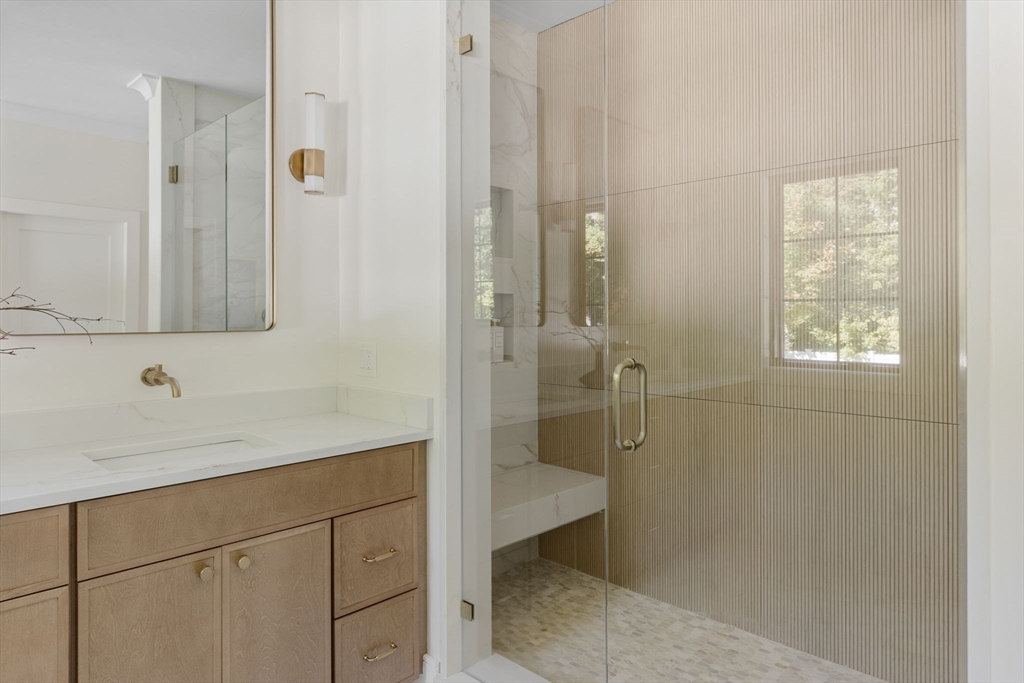 310 Oakland Street Wellesley, MA 02481 - Photo 25 of 33 a bathroom with a shower sink and mirror