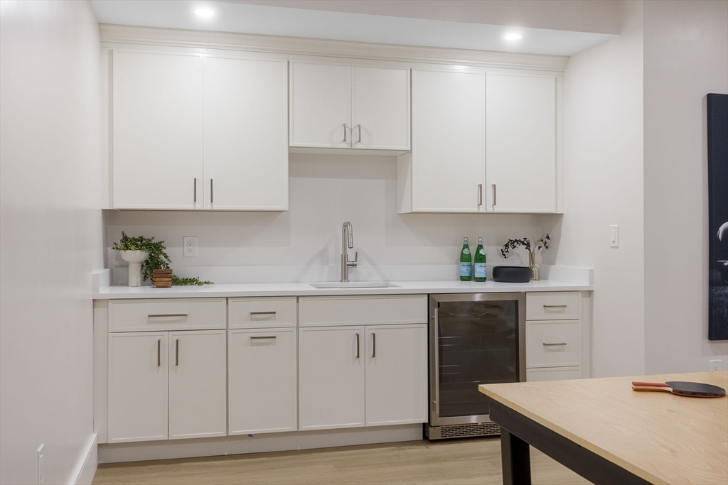 310 Oakland Street Wellesley, MA 02481 - Photo 29 of 33 a kitchen with white cabinets and sink
