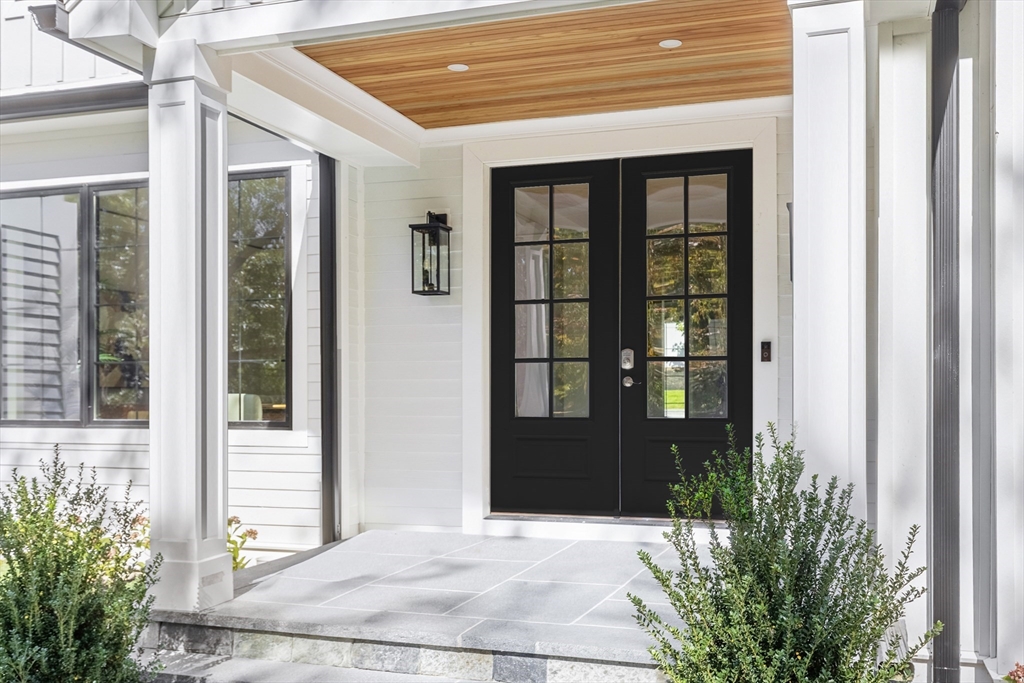 310 Oakland Street Wellesley, MA 02481 - Photo 3 of 33 a front view of a house with a yard