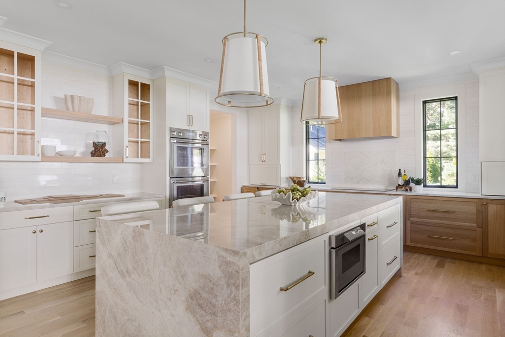 310 Oakland Street Wellesley, MA 02481 - Photo 6 of 33 a kitchen with white cabinets and white appliances