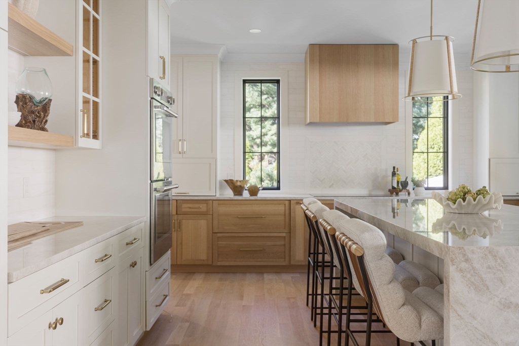 310 Oakland Street Wellesley, MA 02481 - Photo 7 of 33 a bathroom with a granite countertop double vanity sink a mirror and a bathtub