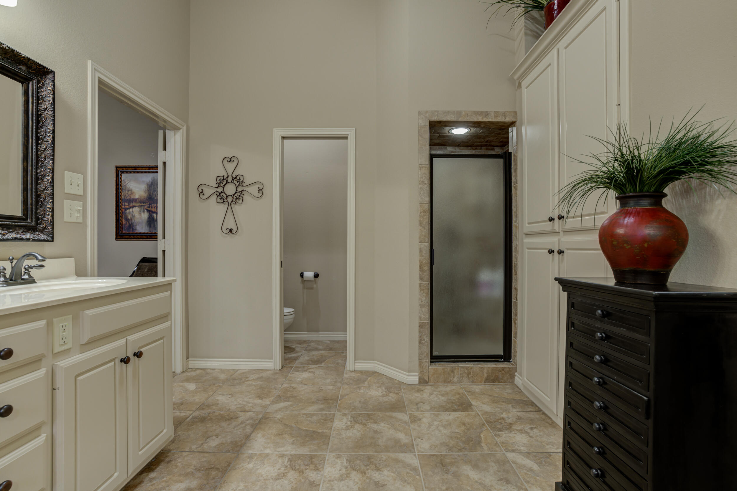 6008 89th Street Lubbock, TX 79424 - Photo 35 of 61 a bathroom with a sink and a mirror