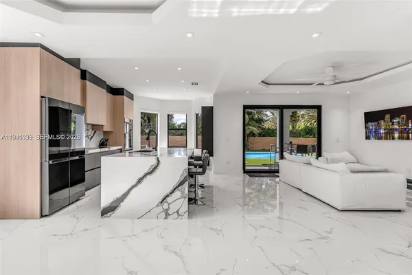 a large white building with kitchen view and a large window