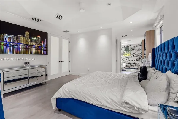 a bedroom with a bed and a book shelf