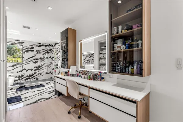 a bathroom with a sink a vanity and a window
