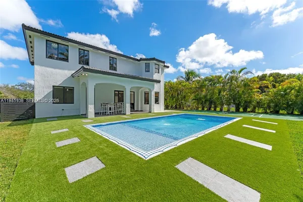 a view of an house with swimming pool and porch