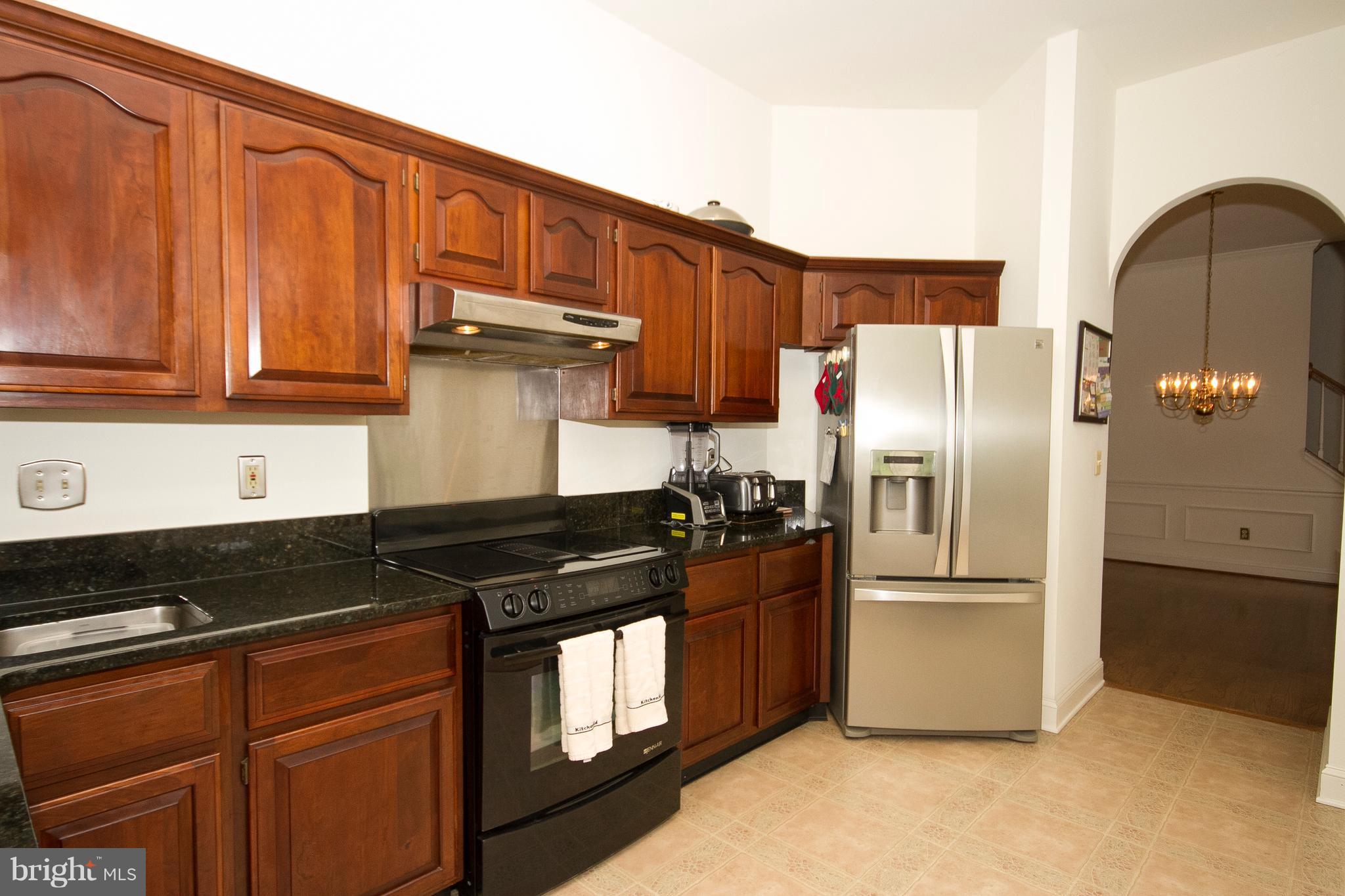 4 Roland Place Bel Air, MD 21014 - Photo 13 of 22 a kitchen with granite countertop a refrigerator stove and cabinets