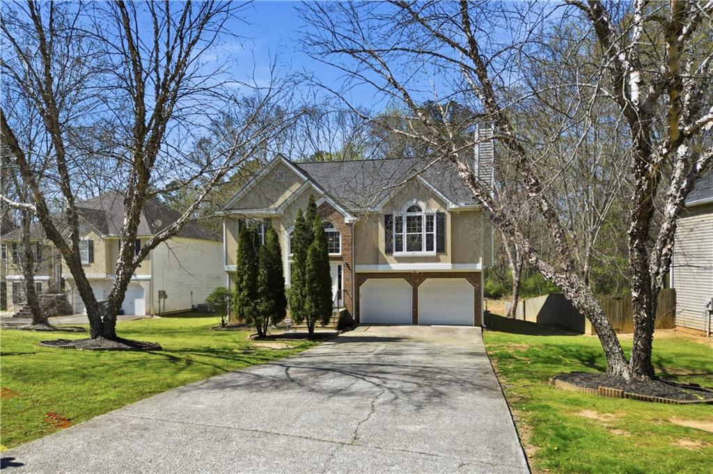 a front view of house with yard and green space