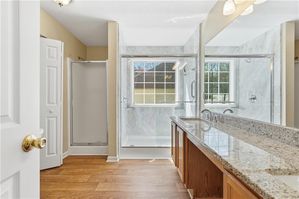 1488 Bellemeade Farms Road Southwest Marietta, GA 30008 - Photo 13 of 31 a bathroom with granite countertop shower and a sink
