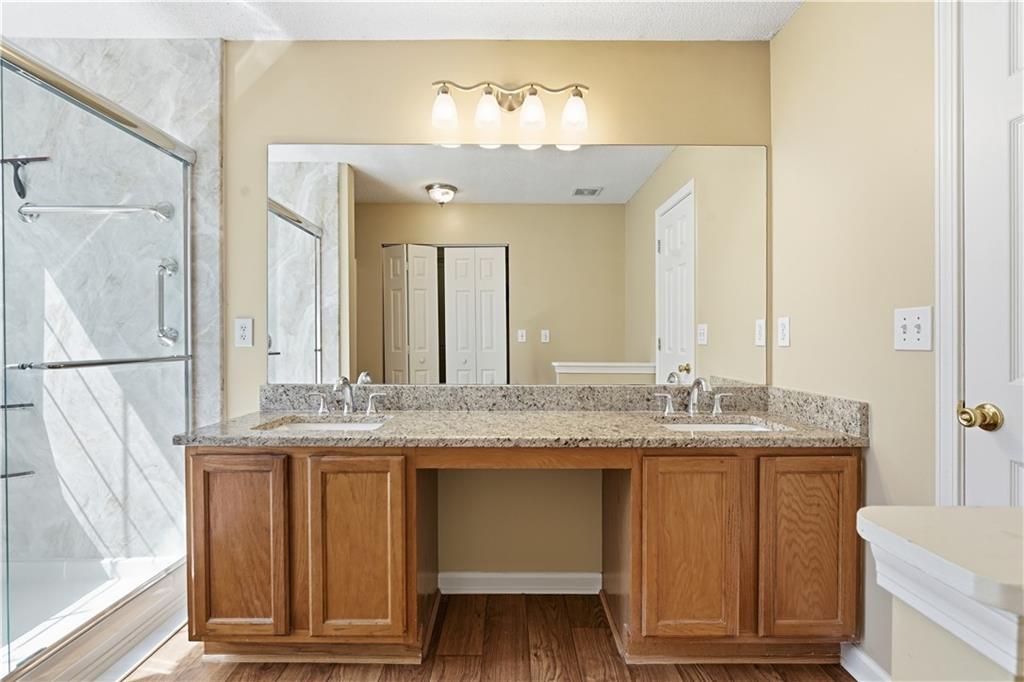 1488 Bellemeade Farms Road Southwest Marietta, GA 30008 - Photo 15 of 31 a bathroom with a granite countertop sink and a mirror