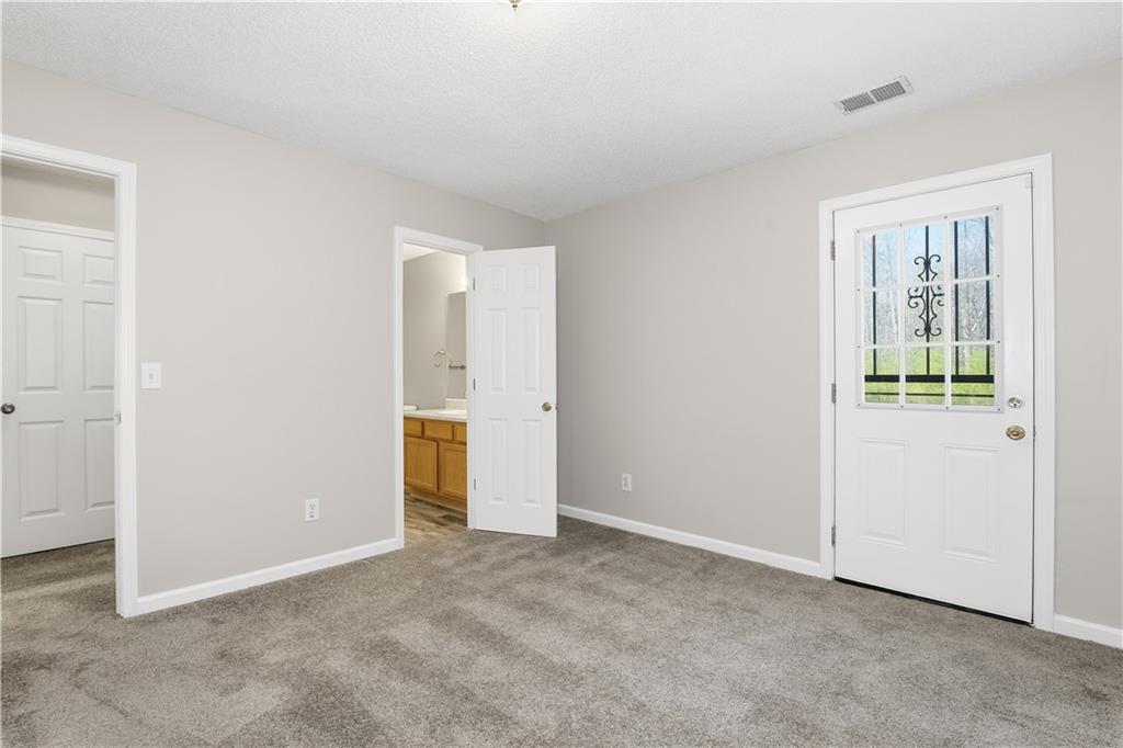 1488 Bellemeade Farms Road Southwest Marietta, GA 30008 - Photo 25 of 31 an empty room with windows and entrance to other room