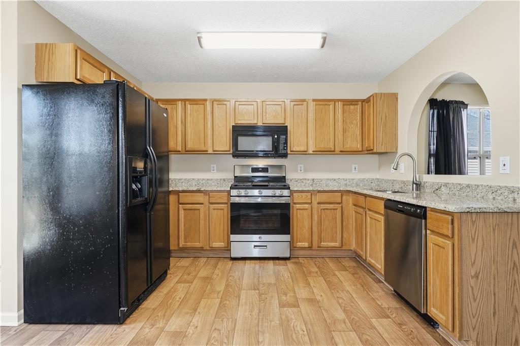 1488 Bellemeade Farms Road Southwest Marietta, GA 30008 - Photo 8 of 31 a kitchen with granite countertop a refrigerator and a sink
