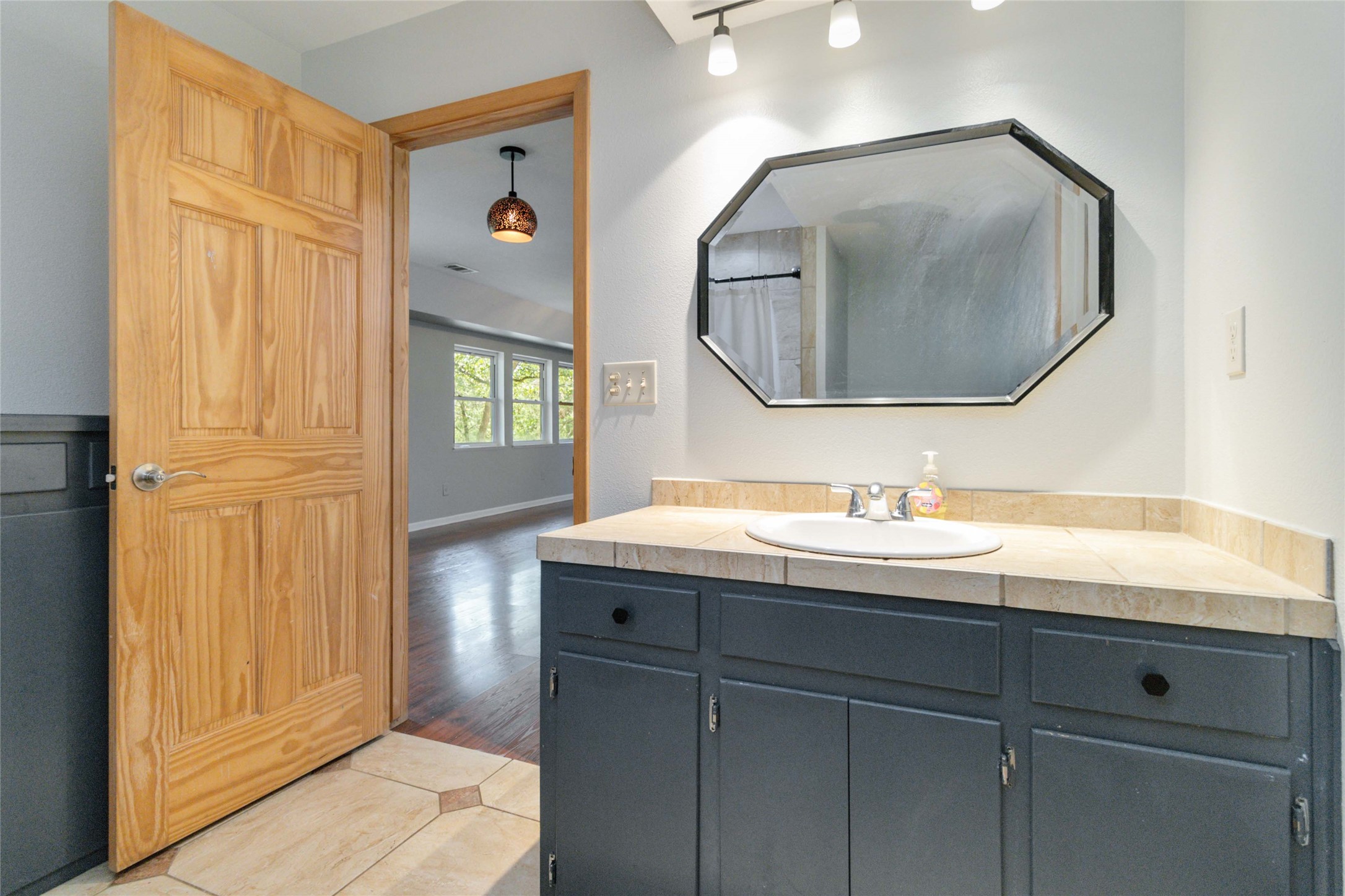 180 Ironstone Road Smithville, TX 78957 - Photo 10 of 37 Bathroom with vanity, a shower with curtain, light tile patterned floors, and rail lighting