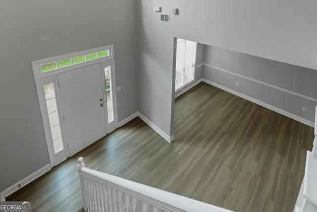 a view of an empty room and wooden floor