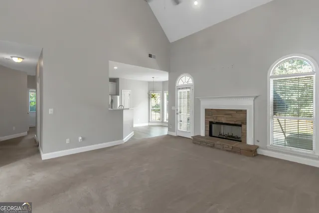 a view of a kitchen with a sink and dishwasher a refrigerator with white cabinets