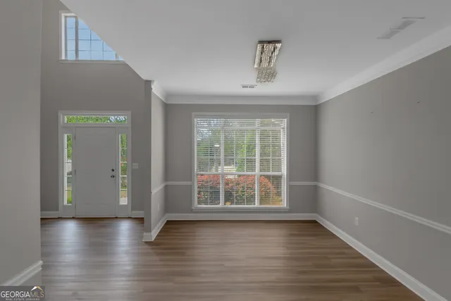 wooden floor in an empty room with a window