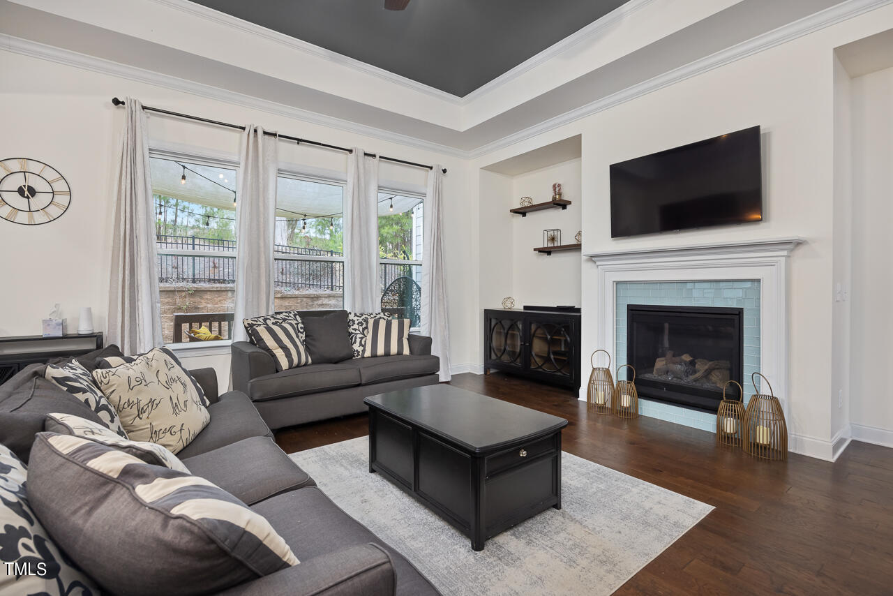5109 Landguard Drive Raleigh, NC 27613 - Photo 11 of 47 a living room with furniture a flat screen tv and a fireplace