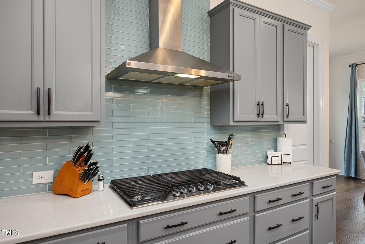 5109 Landguard Drive Raleigh, NC 27613 - Photo 17 of 47 a kitchen with granite countertop cabinets and a stove