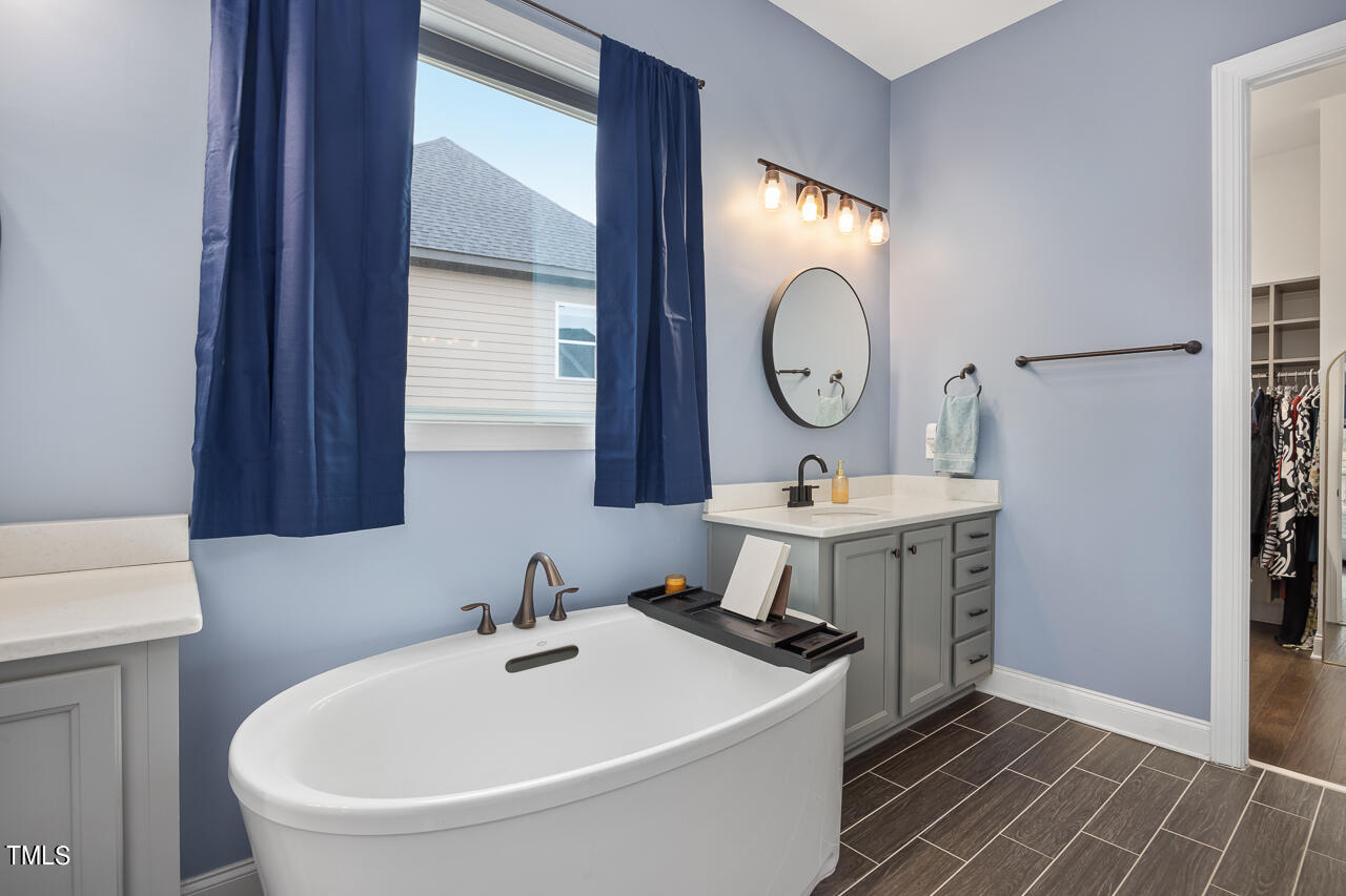 5109 Landguard Drive Raleigh, NC 27613 - Photo 23 of 47 a bathroom with a sink mirror and a toilet