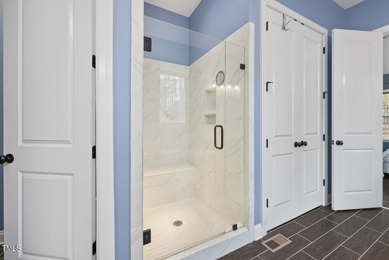 5109 Landguard Drive Raleigh, NC 27613 - Photo 25 of 47 a bathroom with a shower and a glass door