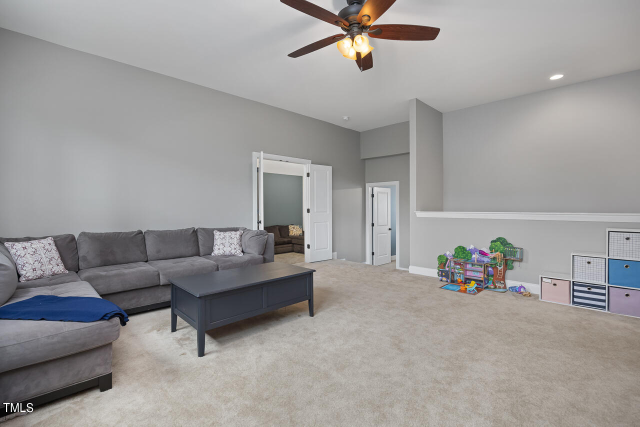 5109 Landguard Drive Raleigh, NC 27613 - Photo 26 of 47 a living room with furniture and a chandelier