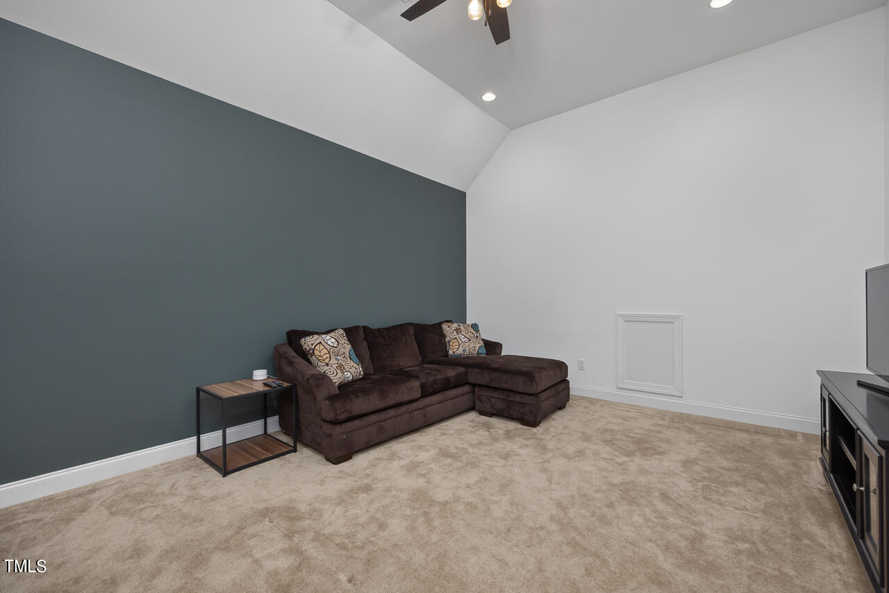 5109 Landguard Drive Raleigh, NC 27613 - Photo 28 of 47 a living room with furniture and a flat screen tv