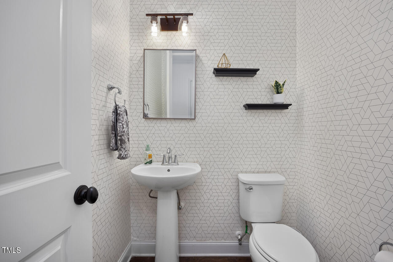 5109 Landguard Drive Raleigh, NC 27613 - Photo 29 of 47 a bathroom with a toilet sink and mirror