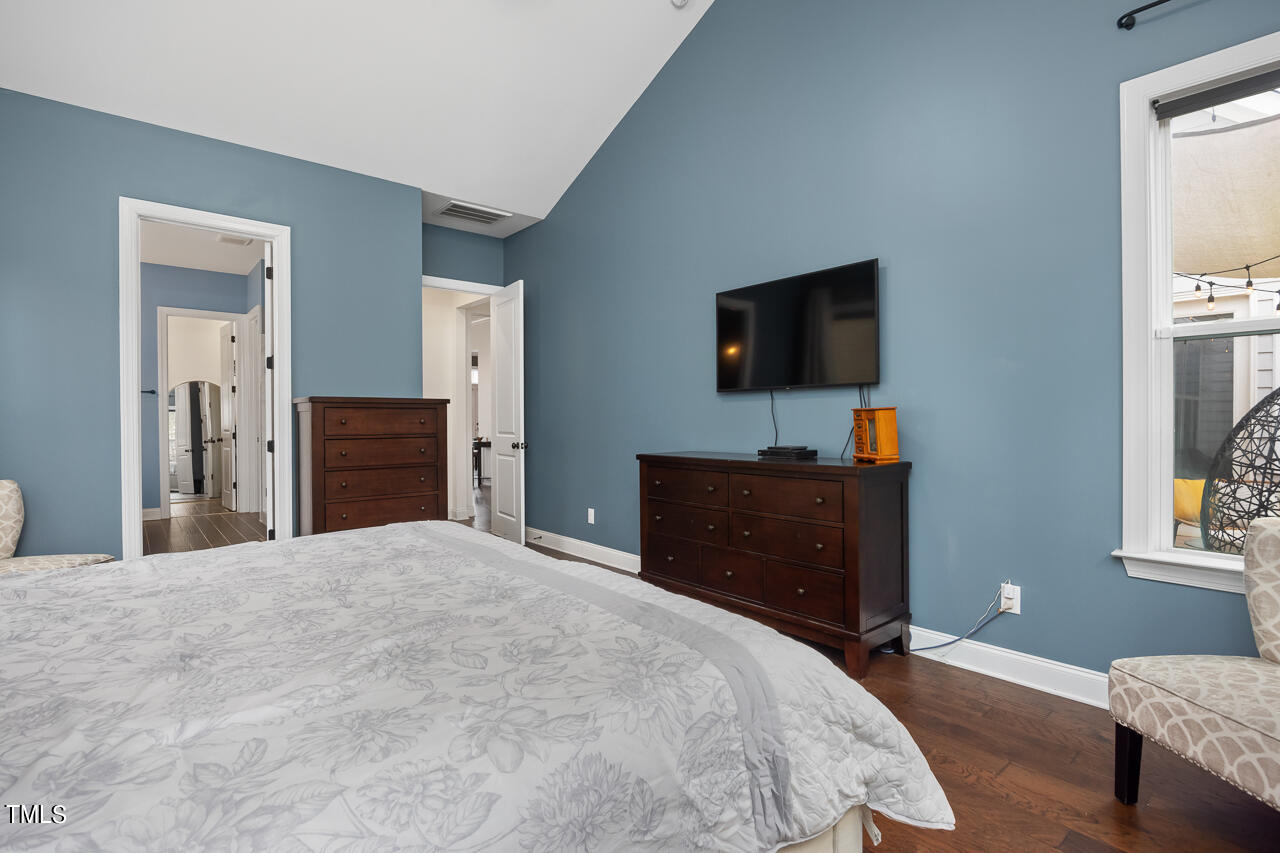 5109 Landguard Drive Raleigh, NC 27613 - Photo 31 of 47 a bedroom with a bed and a flat screen tv