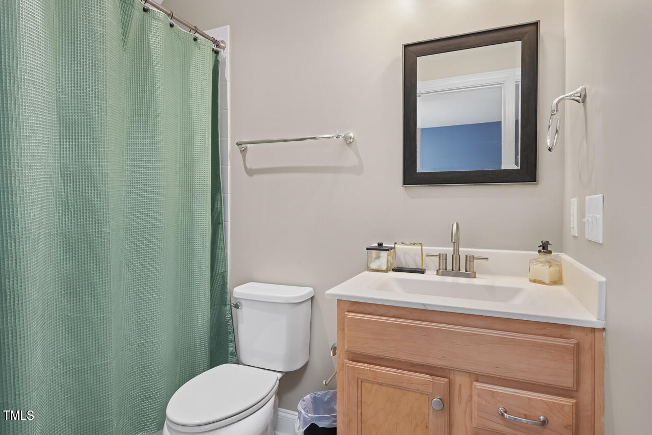 5109 Landguard Drive Raleigh, NC 27613 - Photo 36 of 47 a bathroom with a toilet sink vanity and mirror