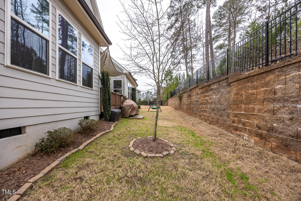 5109 Landguard Drive Raleigh, NC 27613 - Photo 45 of 47 a backyard of a house with lots of green space