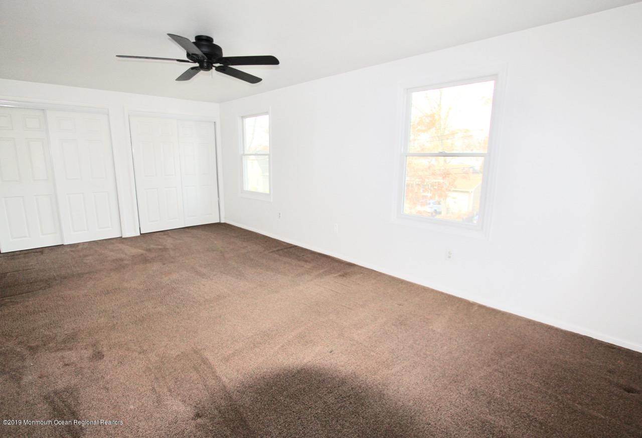 412 Ely Road Neptune Township, NJ 07753 - Photo 13 of 15 an empty room with a window and a ceiling fan
