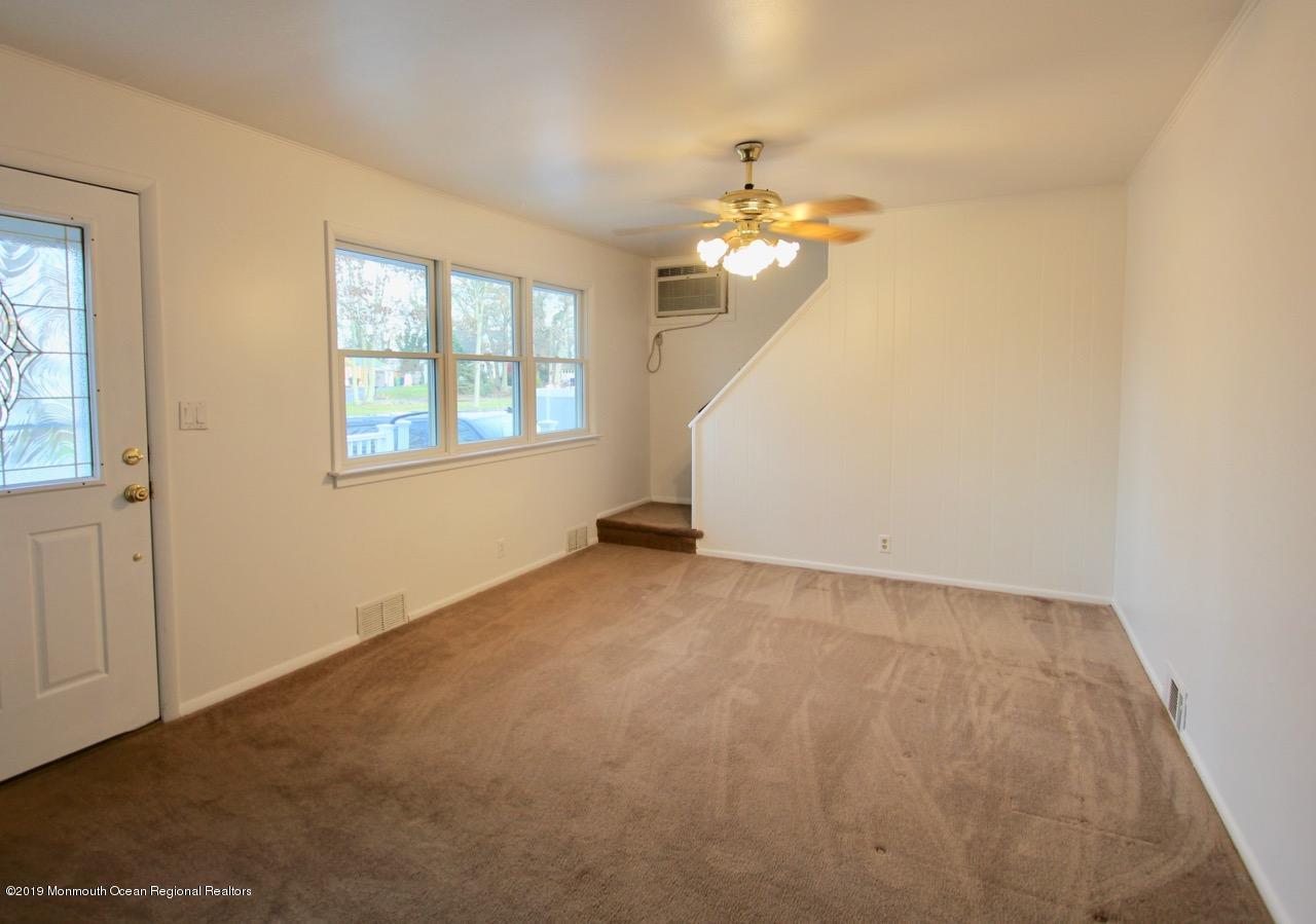 412 Ely Road Neptune Township, NJ 07753 - Photo 6 of 15 wooden floor in an empty room with a window