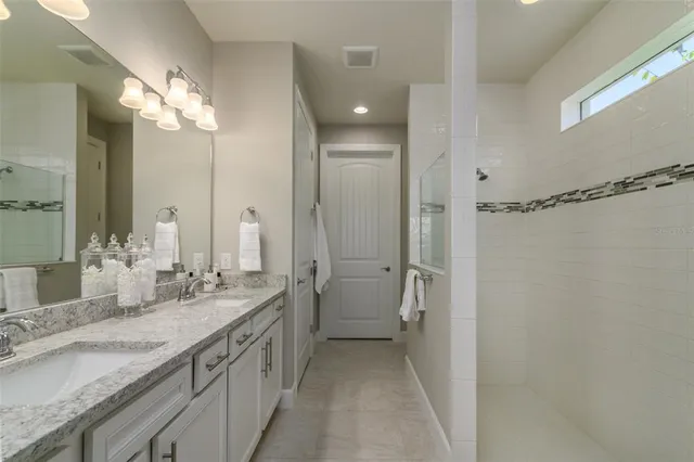 a bathroom with a double vanity sink mirror and double