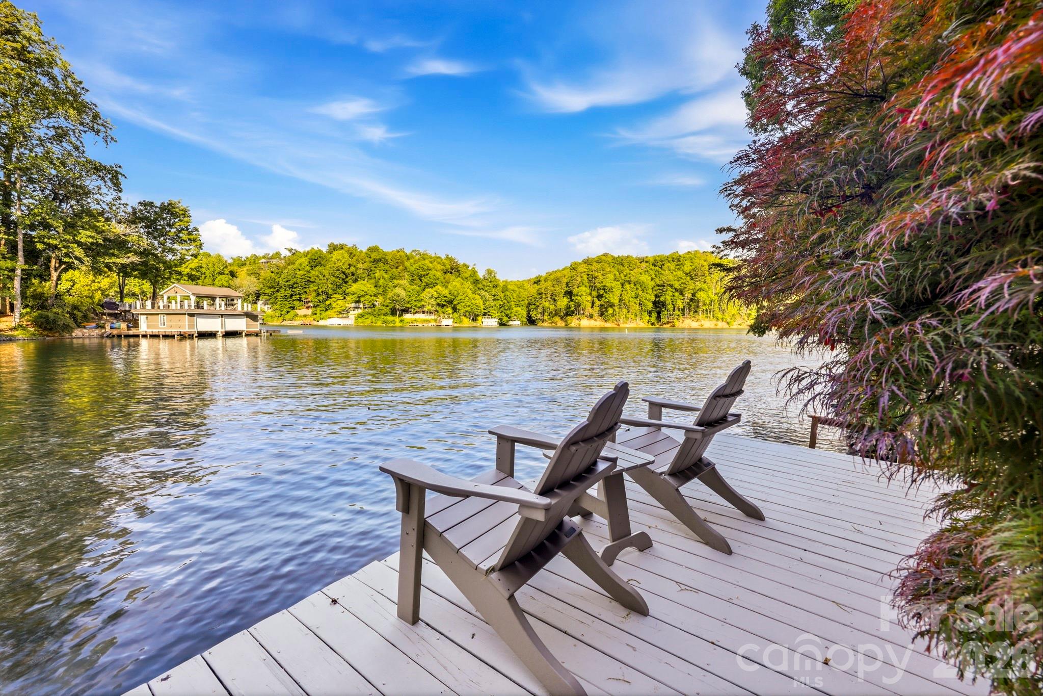 151 Garner Road Lake Lure, NC 28746 - Photo 39 of 48 a view of a lake with table and chairs