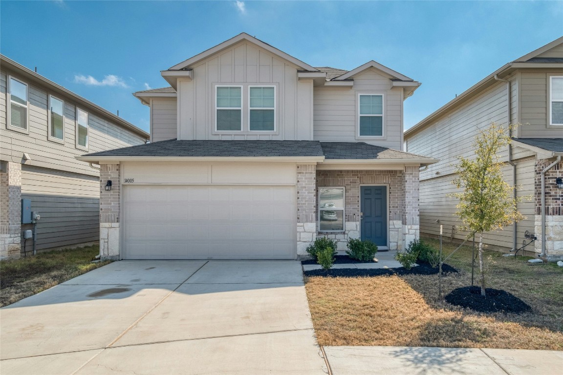 14005 Ballast Drive Elgin, TX 78621 - Photo 1 of 1 a front view of a house with garden