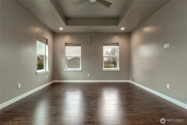 a bathroom with a granite countertop sink a toilet a mirror and vanity