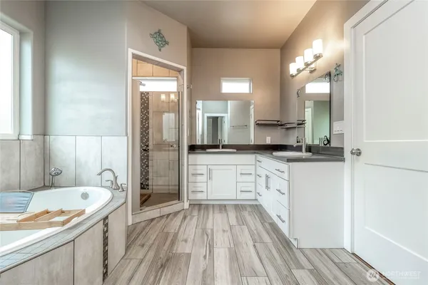 a bathroom with a tub and a window