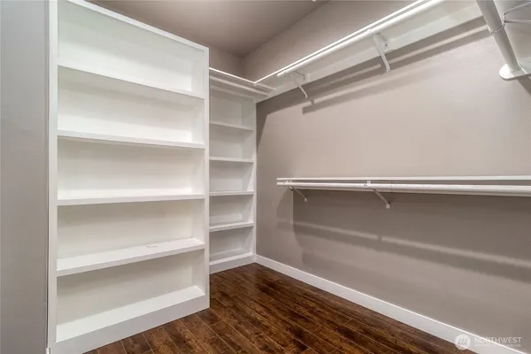 a view of walk in closet with empty racks