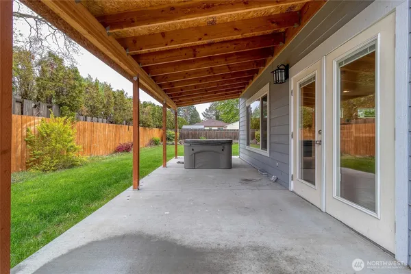 a backyard of a house with table and chairs