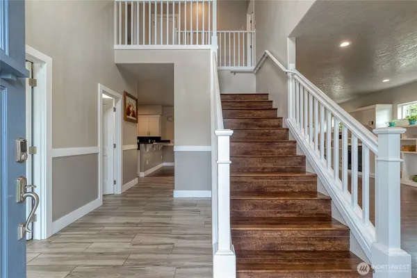 a view of entryway and hall with wooden floor